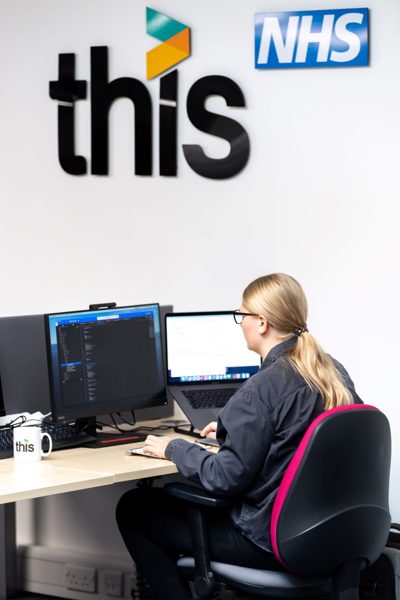 A Female Developer coding in an office.