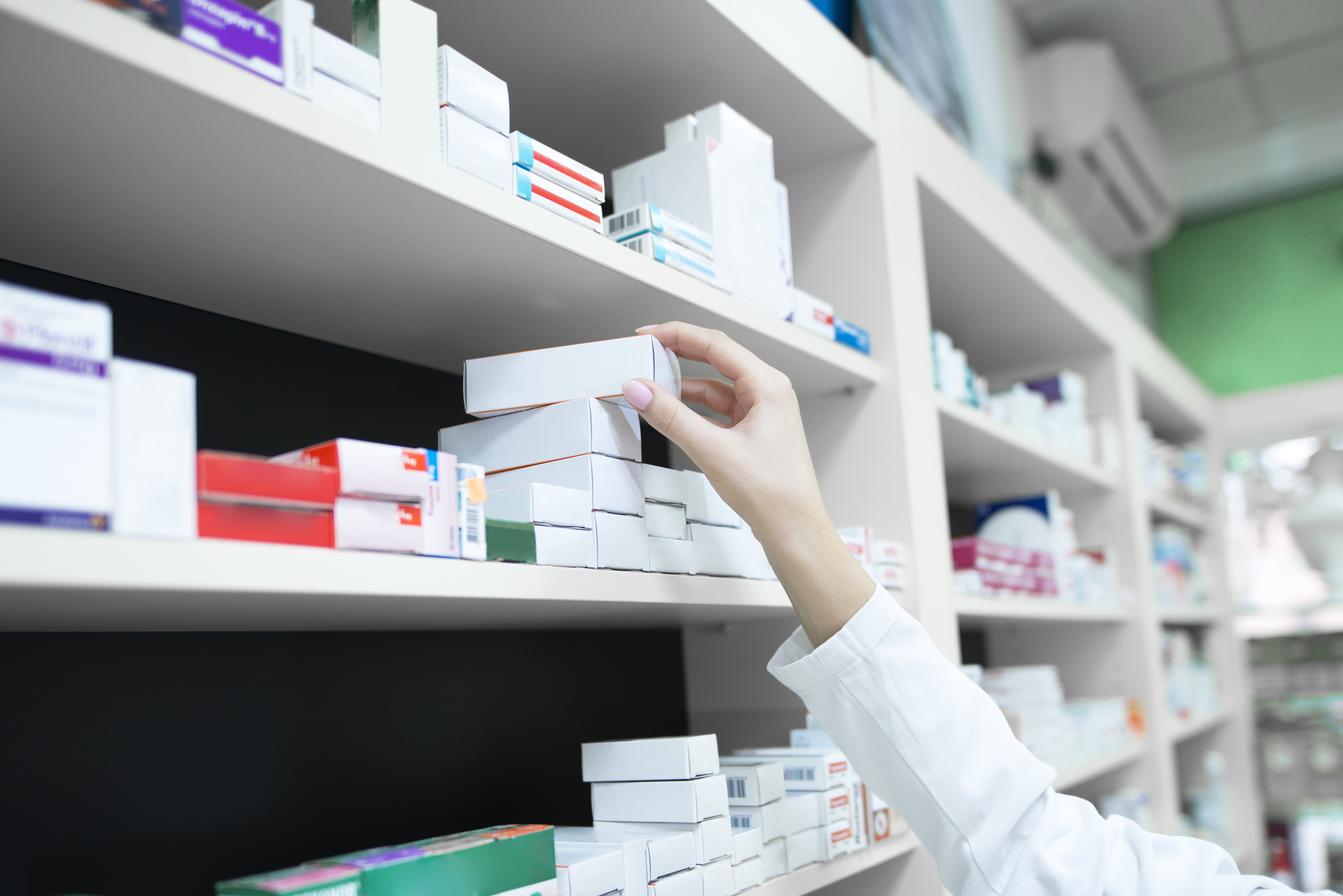 closeup view of a pharmacist grasping a medicine box