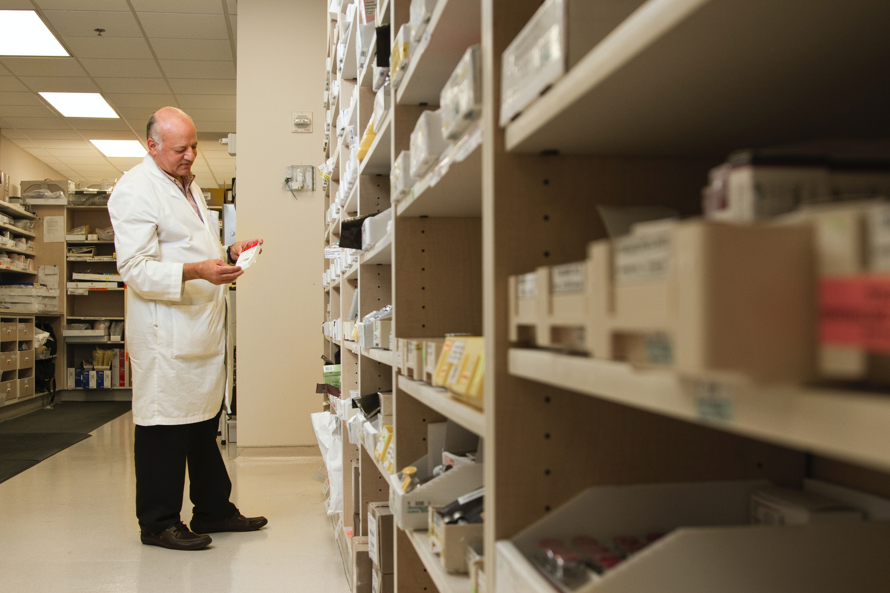 Pharmacist looking at a medicine box