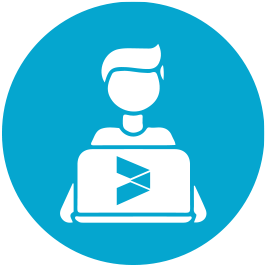 Silhouette of a person sat behind a laptop