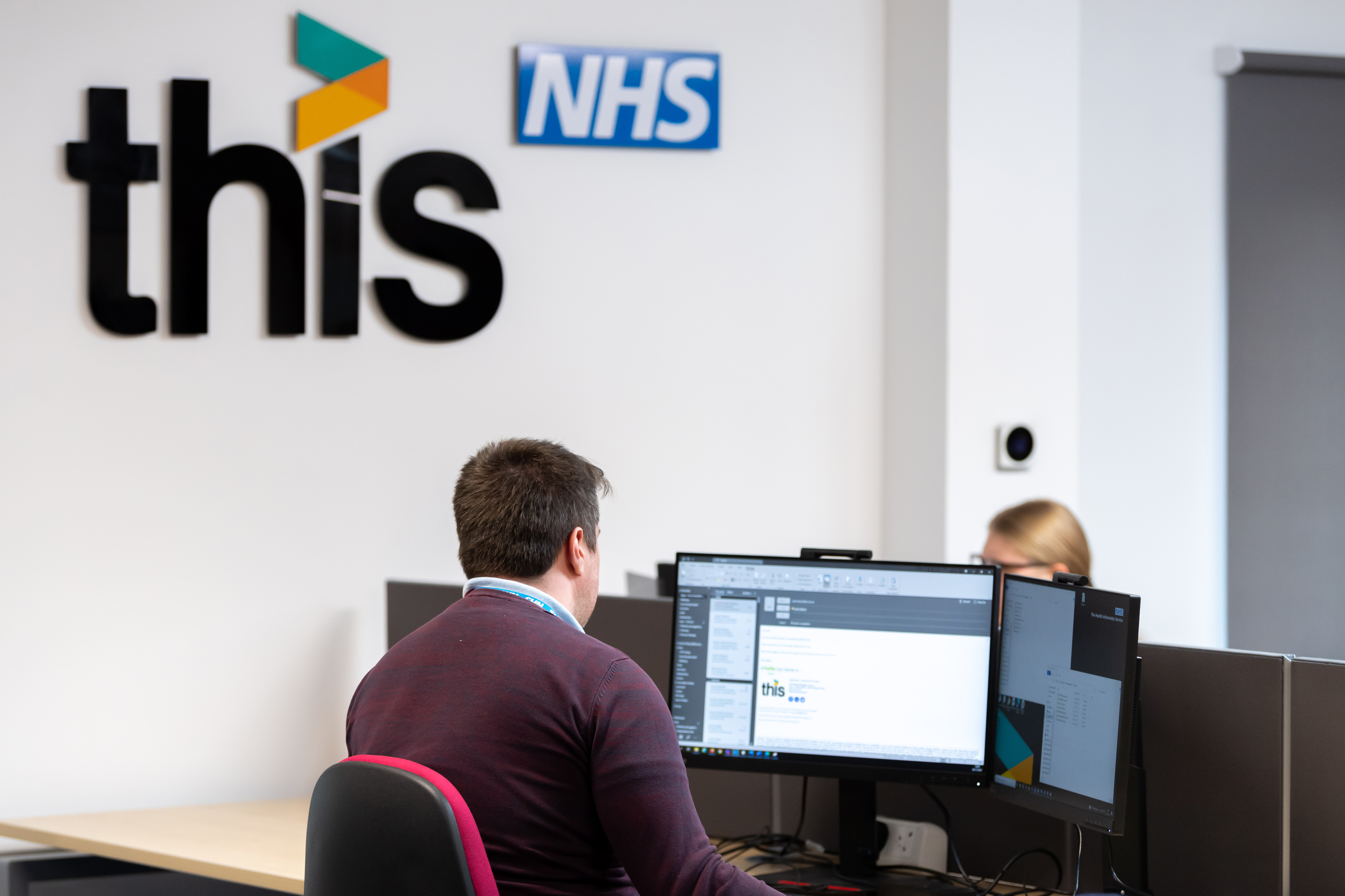 NHS / Healthcare Worker Using A Computer At the 'THIS' office