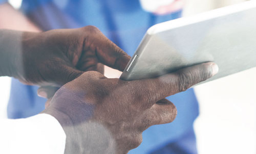 Doctors hands on an iPad