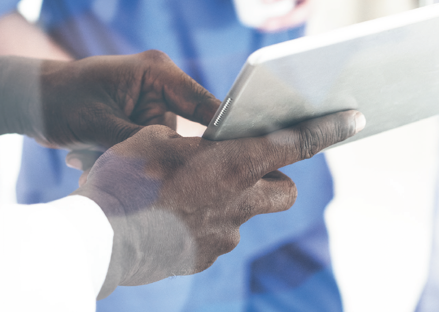 Doctors hands on an iPad